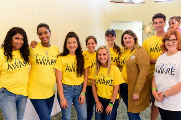 9 people wearing foster care aware shirts at the event