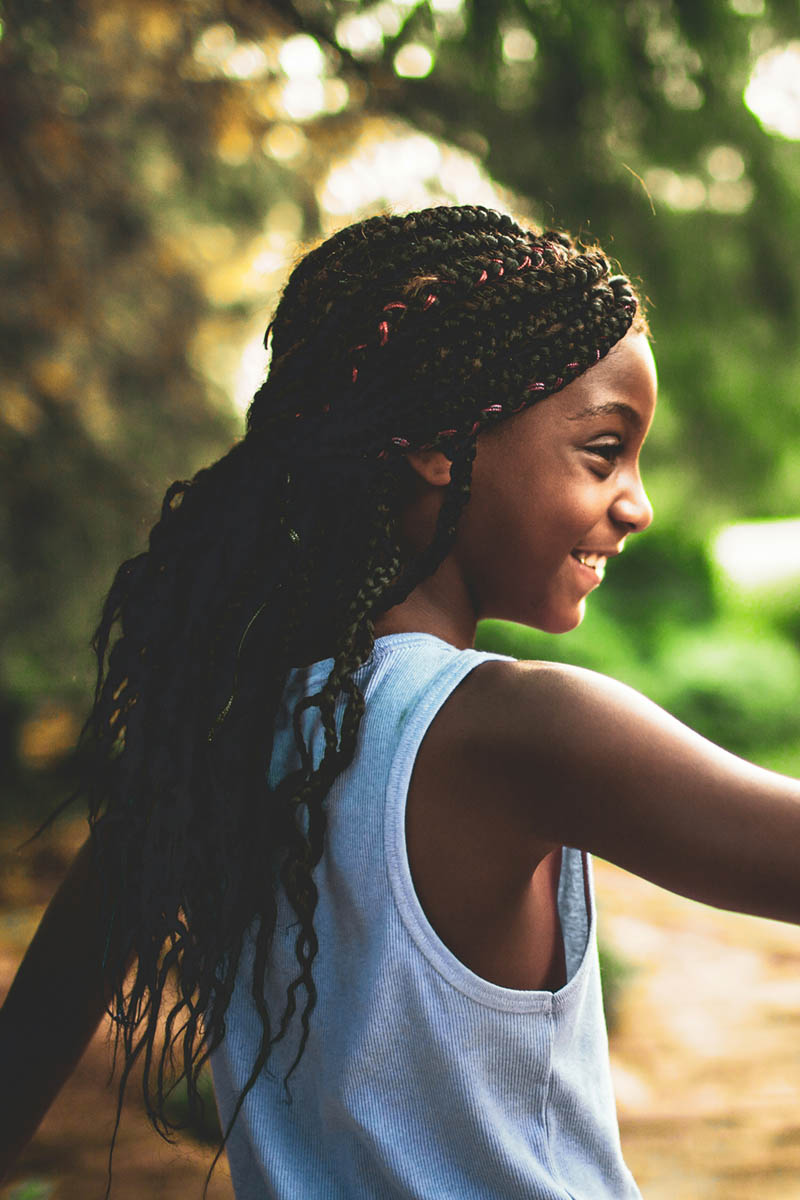 Happy, smiling Black girl with braids