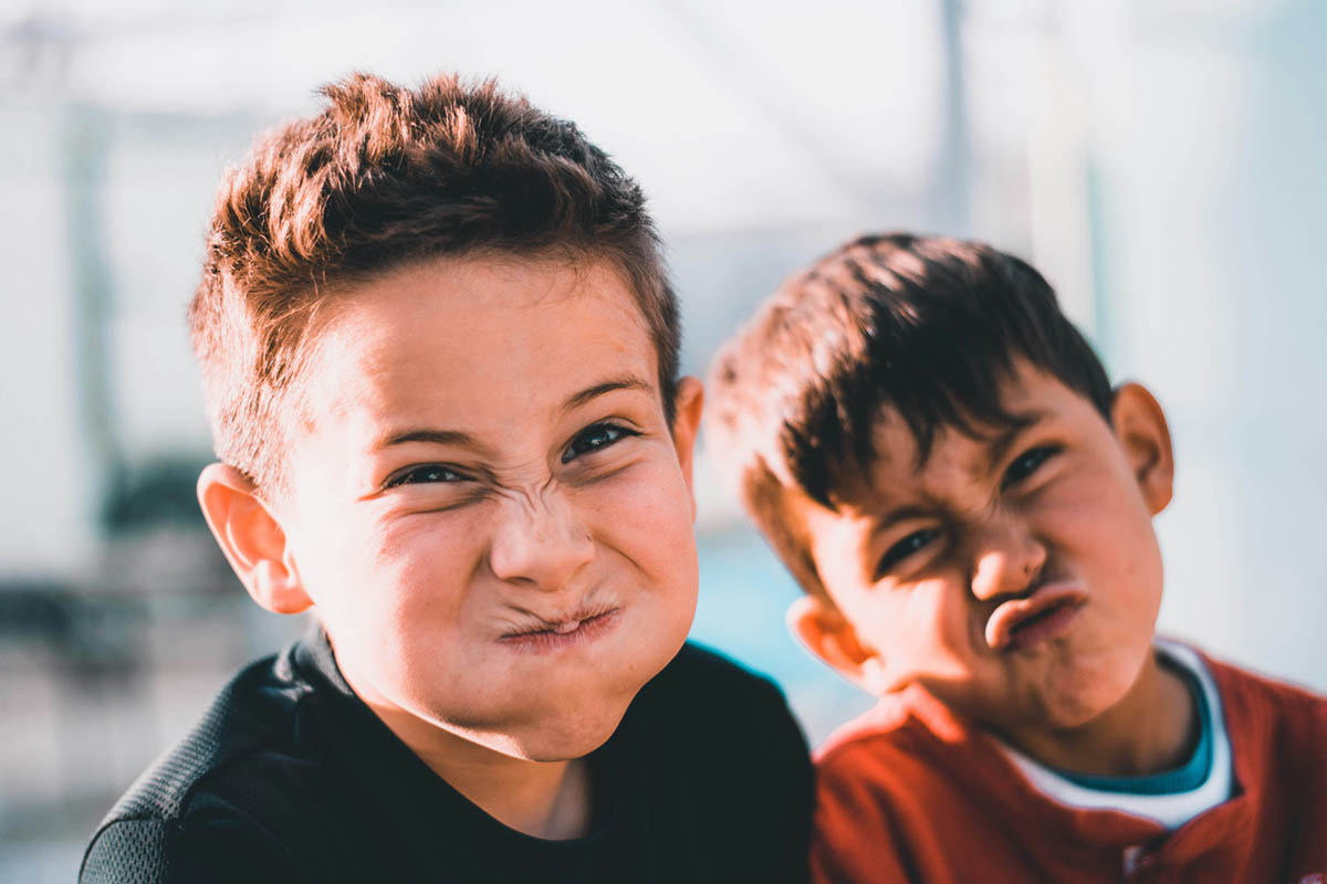 Two young boys making funny faces at the camera