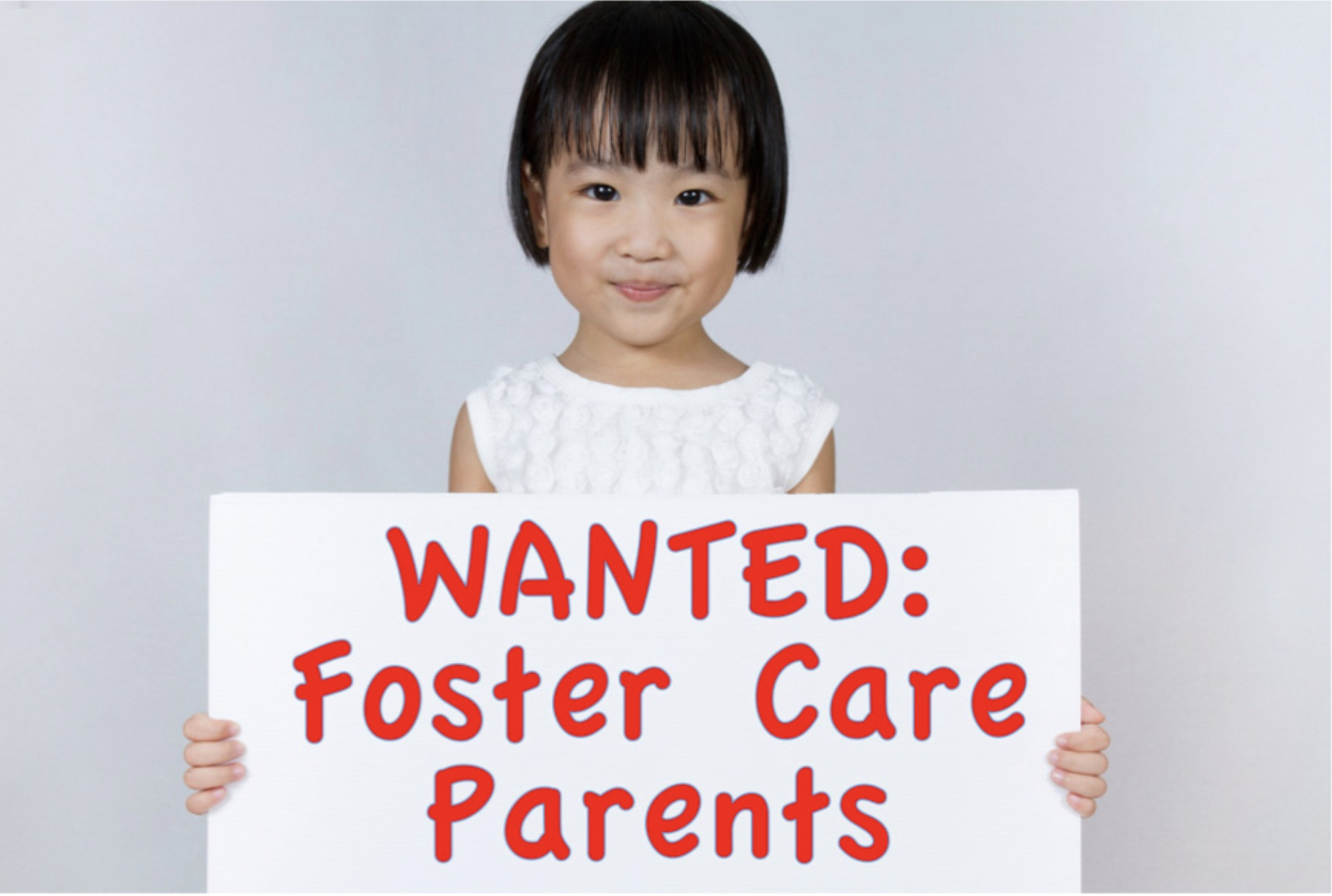 Photo of young girl holding sign that says "WANTED: Foster Care Parents."
